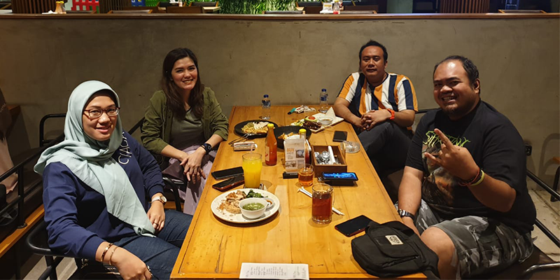 Remote workers in a bali beachside coworking cafe